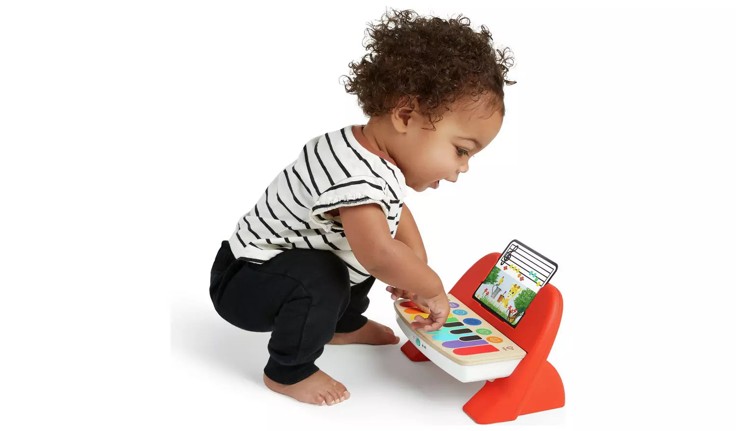 A young child playing with the Baby Einstein Hape Magic Touch Piano