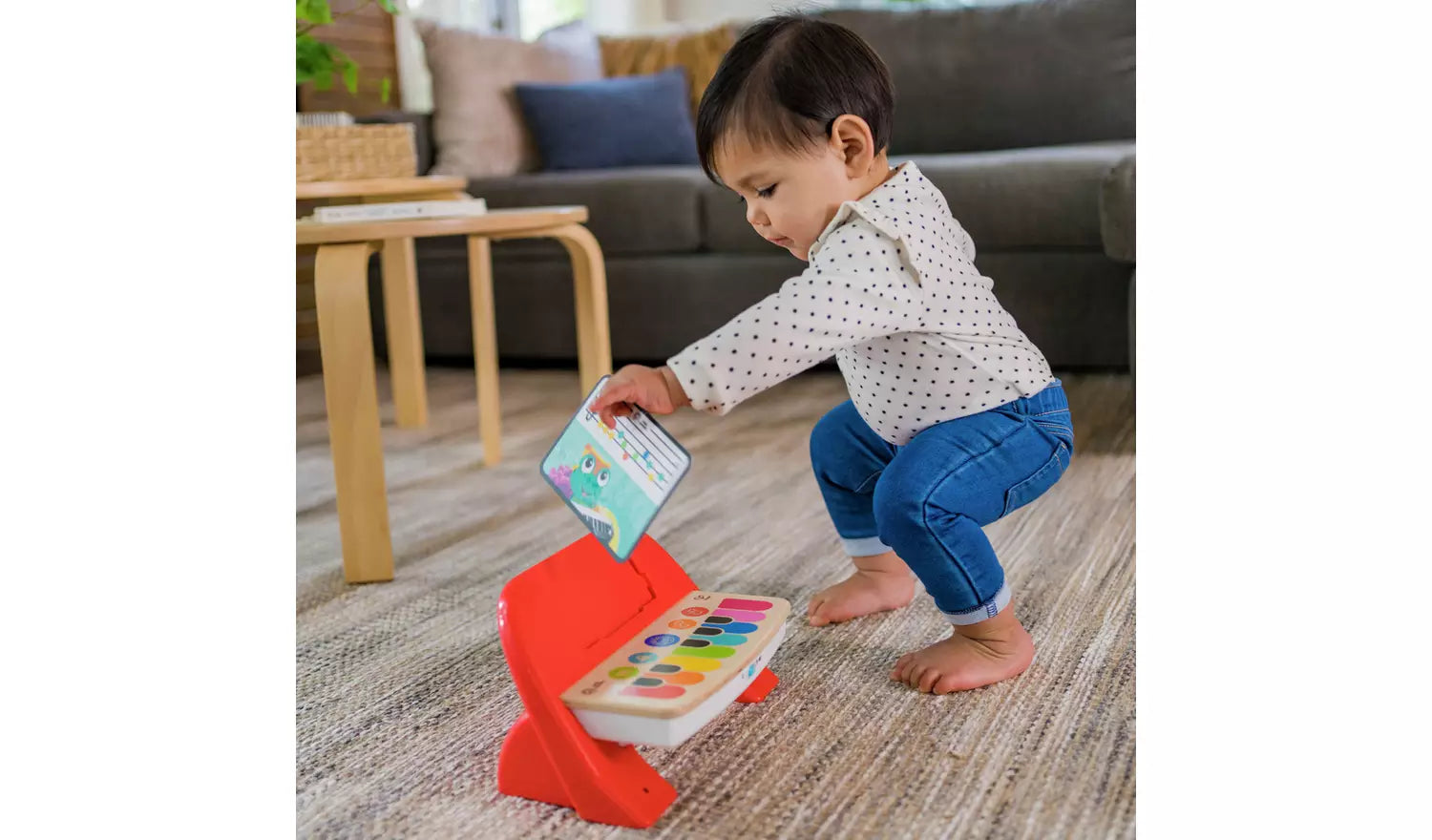 A young child playing with the Baby Einstein Hape Magic Touch Piano