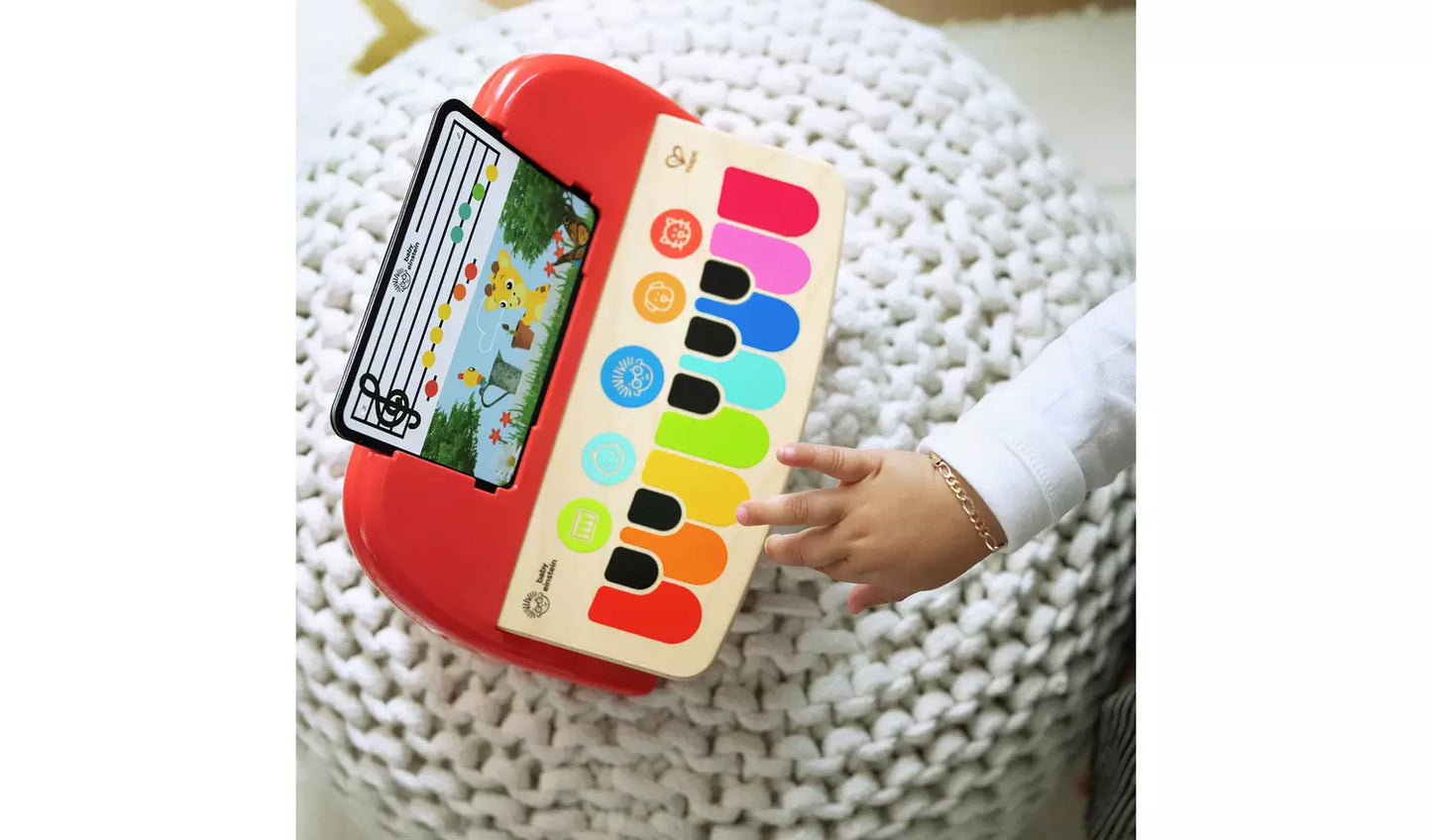 A young child playing with the Baby Einstein Hape Magic Touch Piano