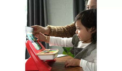 A young child playing with the Baby Einstein Hape Magic Touch Piano