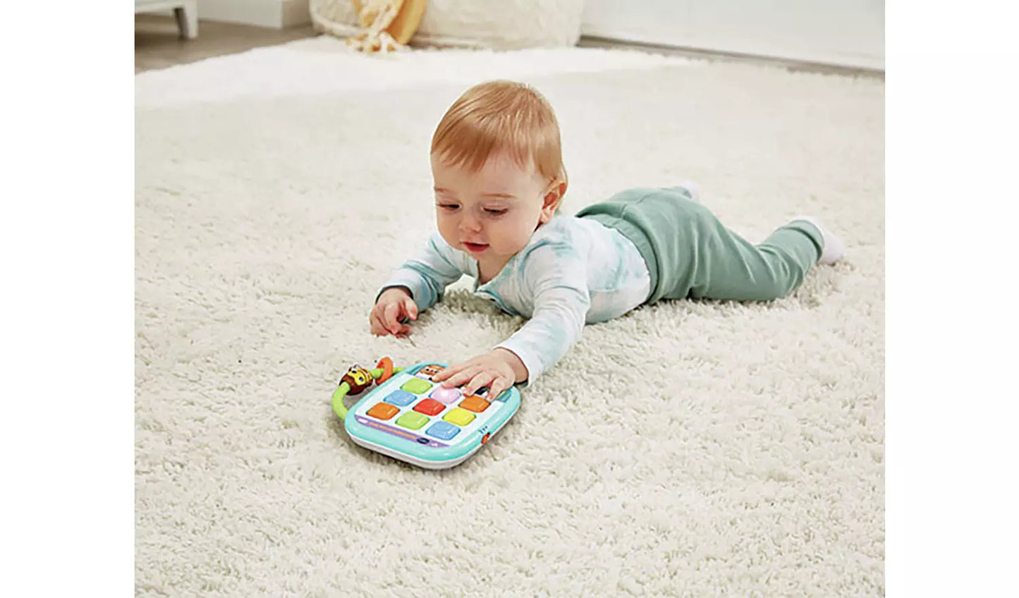 Young child playing with the Vtech Squishy Lights Learning Tablet.