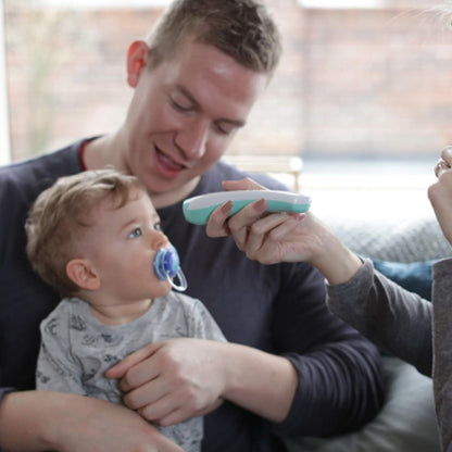 Photo of an adult using the thermometer on a young child.