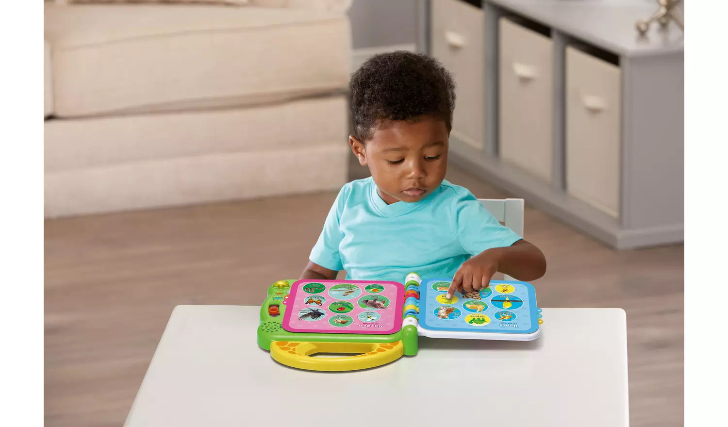 Photo of a young child playing with the LeapFrog Friends 100 Animal Book