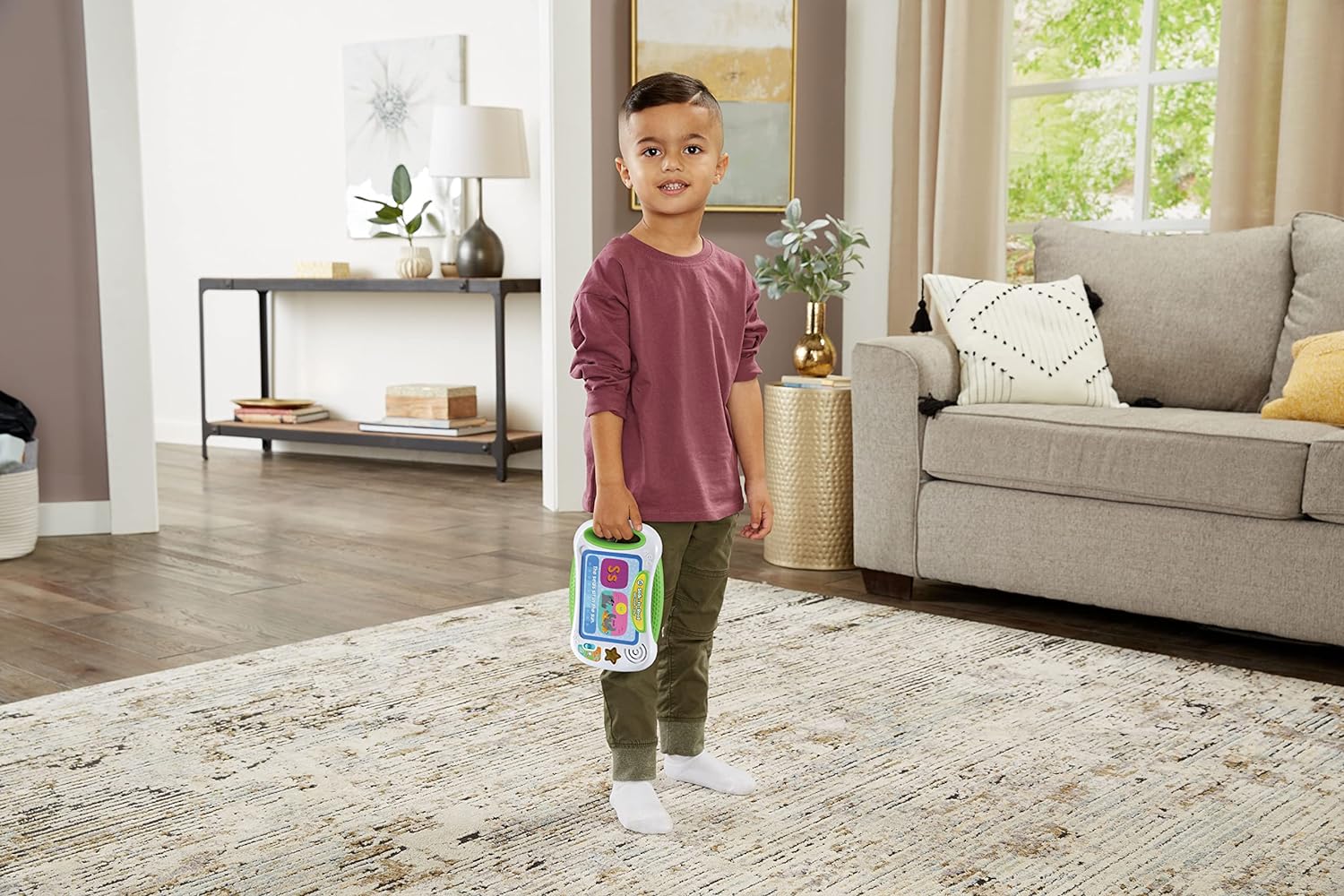 Young child holding the Leapfrog Slide to Read ABC Flash Cards