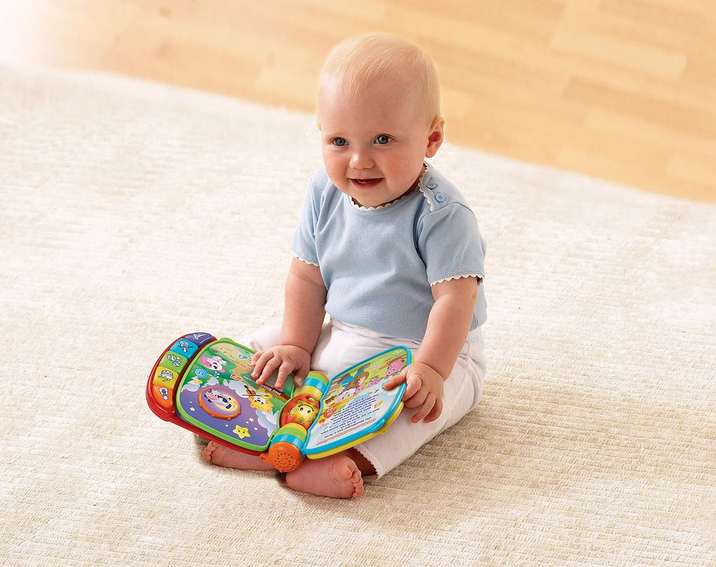 Photo of a young child playing with the VTech Baby Musical Rhymes Book