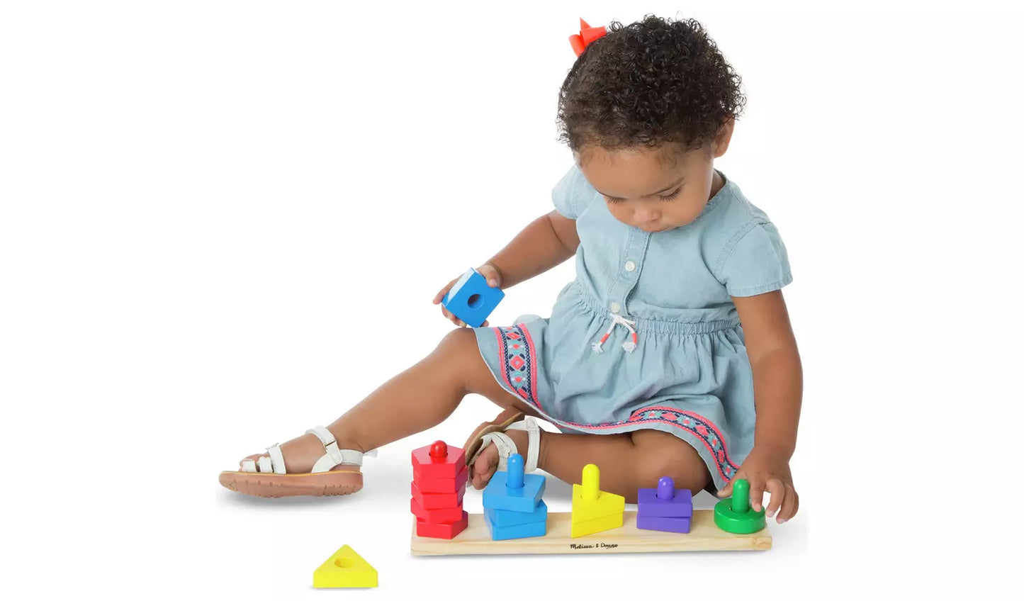 Young child playing with the Melissa & Doug Stack Sort Board Toy