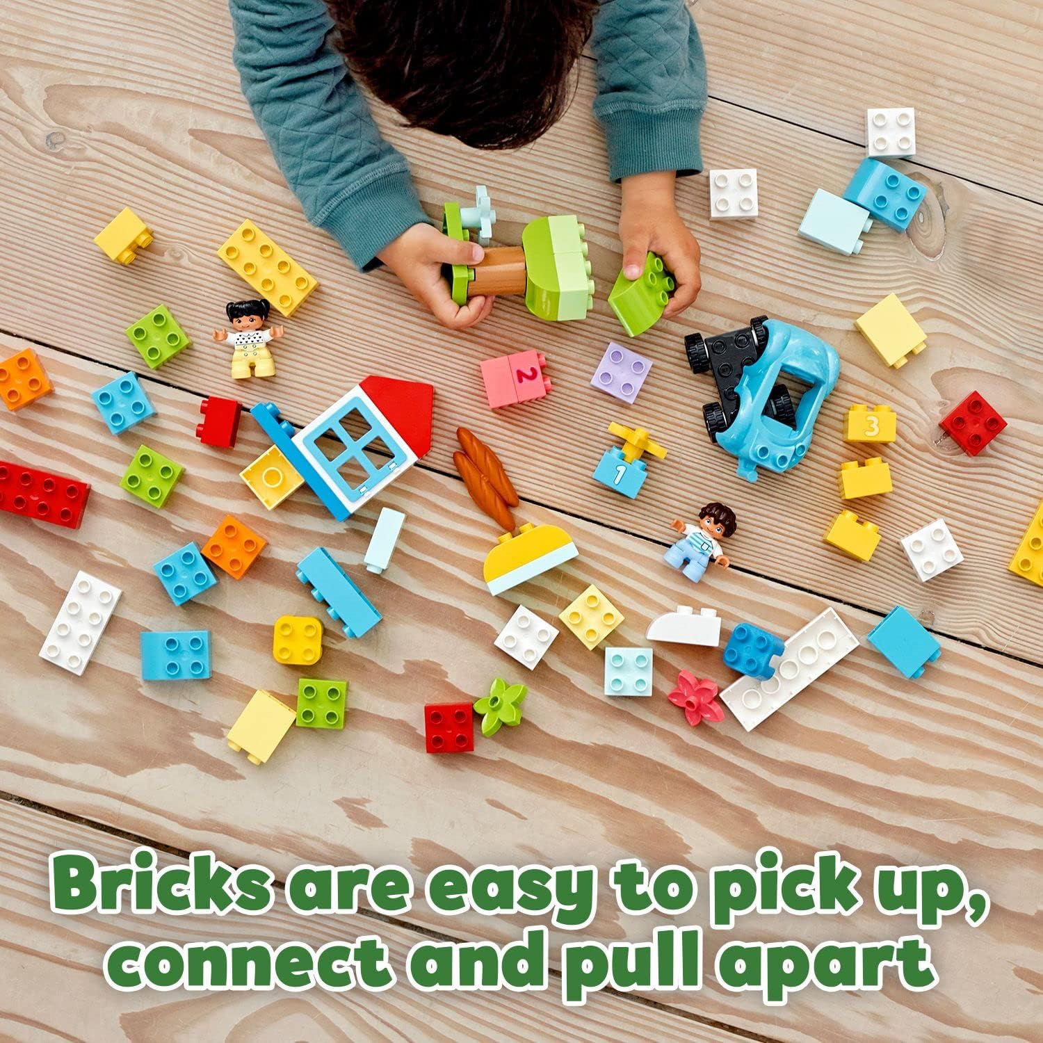 Boy playing with the Duplo set - Bricks are easy to pick up, connect and pull apart. 