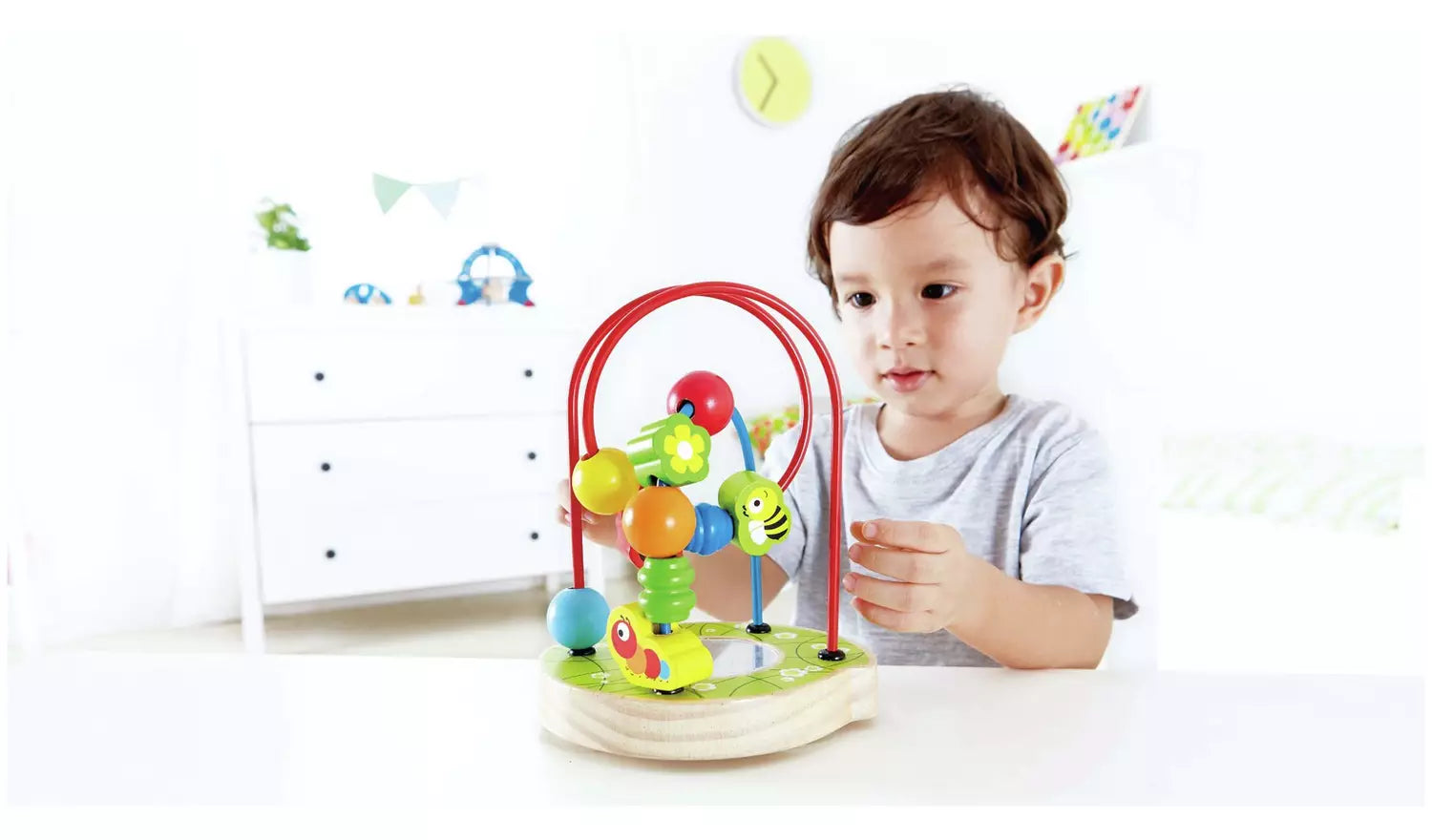 Stock photo of a young child playing with the animal shape hoop puzzle.