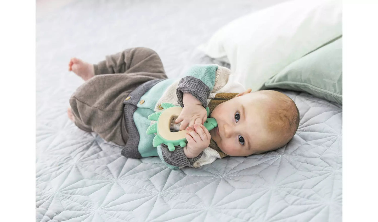 Image of a young baby playing with the hedgehog teether.