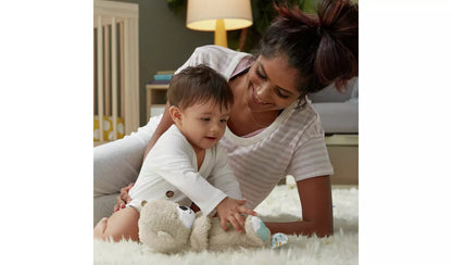 Stock photo of woman and young child playing with the plush otter soother.