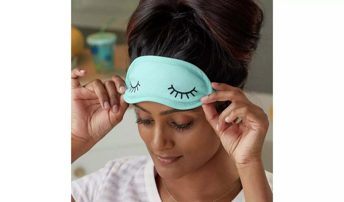 Picture of a woman wearing the soft eye mask.